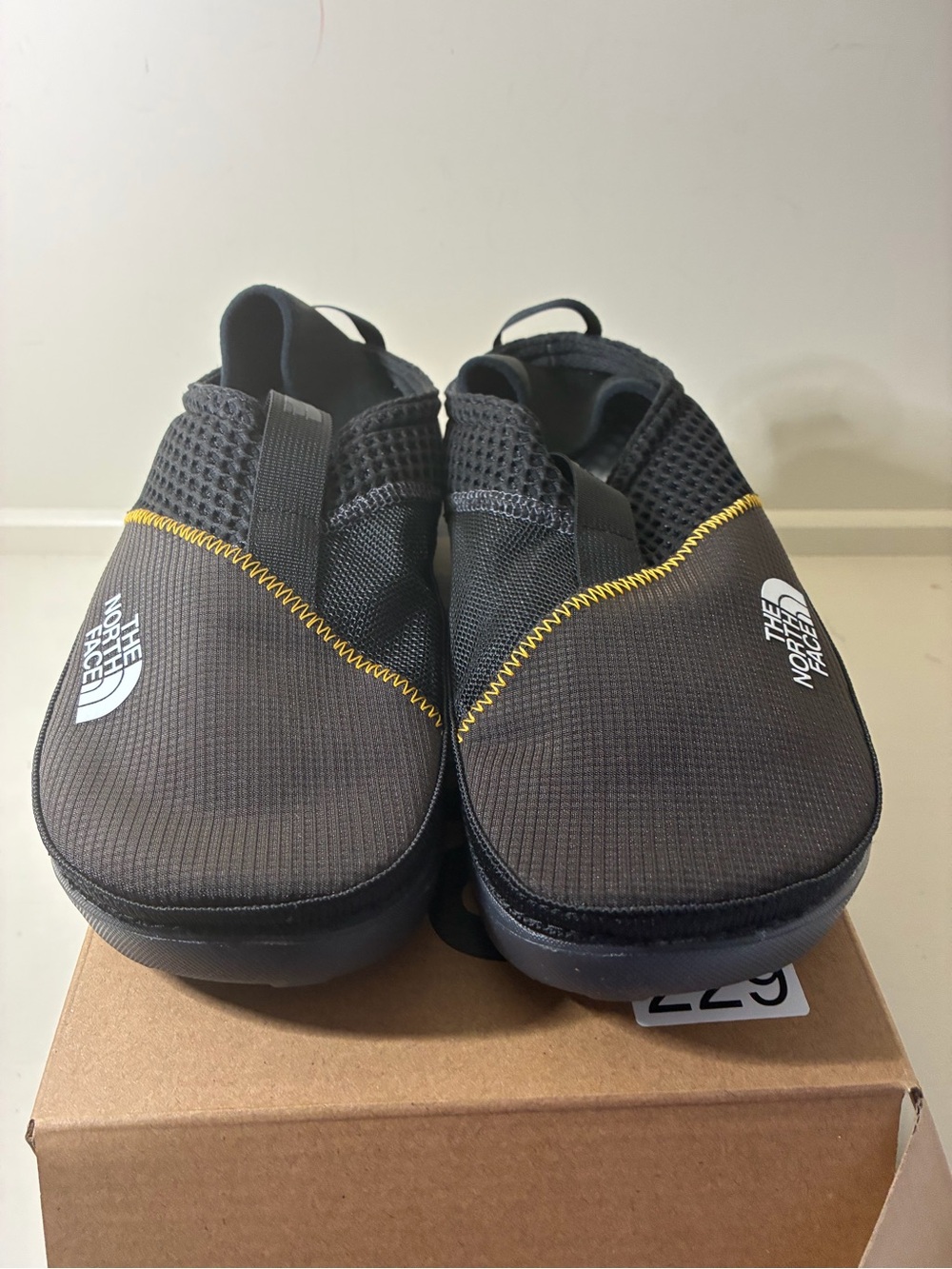 The North Face Black Slip-On Loafers with Yellow Stitching